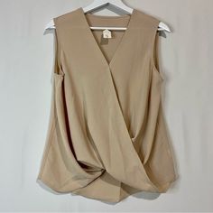 Women’s Sleeveless Faux Wrap V Neck Blouse Tan Size Large New Without Tags Approximate Hanging Measurements Shown In Photos 95% Polyester 5% Spandex Business Casual Summer Sleeveless Girly V Neck *Size Small Sold Beige Sleeveless Blouse Tank Top For Workwear, Beige V-neck Tank Top For Work, Beige Vest For Work, Versatile Sleeveless Office Vest, Versatile Sleeveless Vest For Office, Sleeveless Beige Workwear Blouse, Sleeveless Beige Blouse For Work, Beige Sleeveless Blouse For Workwear, Beige Tank Top For Work