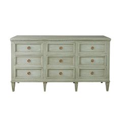 an old dresser with drawers and knobs on the top is painted in pale green