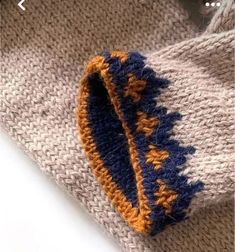 a knitted sweater with an orange and blue stripe