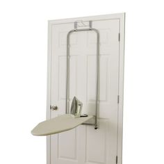 an ironing board mounted to the side of a white door with a handle on it