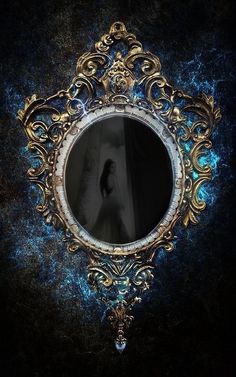 the reflection of a person standing in front of a round mirror on a wall with blue and gold swirls