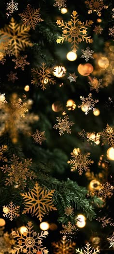 a christmas tree with gold snowflakes on it