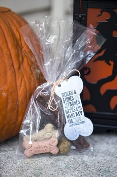 there is a bag of treats next to a pumpkin