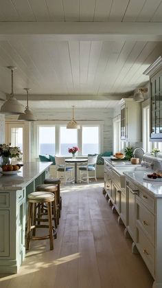 a kitchen filled with lots of counter top space next to a dining room table and chairs