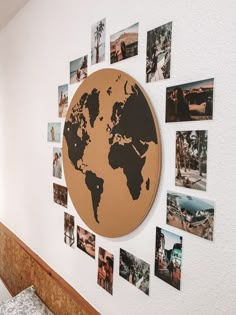 there is a wall with pictures on it that has the world in black and gold