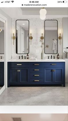 the bathroom is decorated in blue and white with gold accents on the vanity, along with two large mirrors