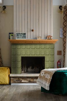 a living room with a fire place next to a bed