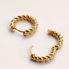 A twisted design inspired by classic ropes, these distinctive earrings add a statement to your ear stack. Our Twisted Hoops are real 18k Gold Plated and are made to last. These hoops are tarnish free when looked after properly. To keep your hoops looking shiny for longer we recommend you remove them before bathing and apply any lotions, perfumes or hairspray before putting on your jewellery. ✦ DIMENSIONS ✦  ・21.5mm in diameter, 4mm thick ✦ MATERIALS ✦  ・Plated with real 18k Gold ✦ CARE ✦  To kee Rope Earrings, Ear Stack, Circle Earrings, Jewelry Earrings Hoops, Handmade Jewellery, Ear Jewelry, Elegant Earrings, Unique Charms, Gold Plated Jewelry