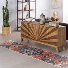 a living room with a rug and wooden furniture