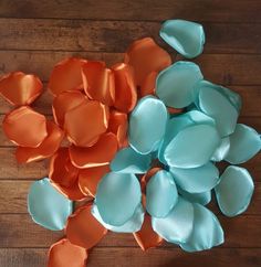 several pieces of blue and orange paper on a wooden surface