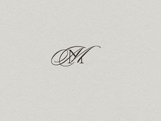 the letter m is inscribed in black ink on a white paper with an elegant monogram