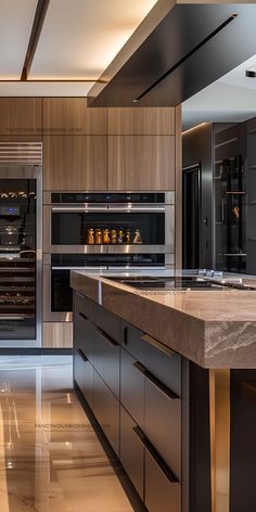 a modern kitchen with marble counter tops and stainless steel appliances