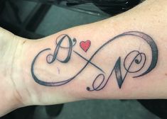 a tattoo with the word love written in cursive writing