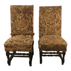 a pair of chairs with floral upholstered back and seat covers on each side