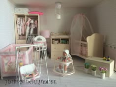 there is a doll house with furniture and accessories in the room, including a baby's crib