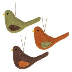 three felt birds hanging from strings on a white background