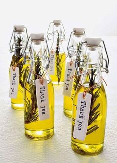 four bottles filled with different types of plants and labels that say they're dry