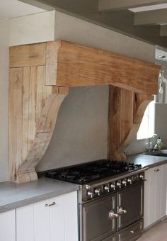 a stove top oven sitting inside of a kitchen next to an oven and countertop