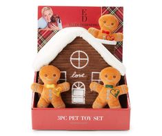 a gingerbread house with two teddy bears in it's gift box for christmas