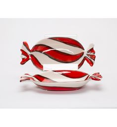 two red and white dishes sitting on top of each other