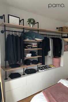 an organized bedroom with clothes and shoes on shelves