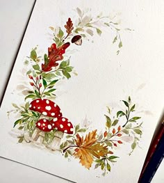 a watercolor painting of an autumn wreath with mushrooms, leaves and acorns