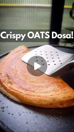 a crepy oats dosa with a spatula on it and the words crispy oats dosa