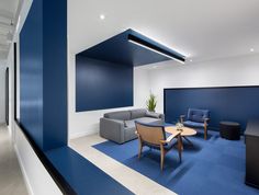 an office with blue carpet and white walls