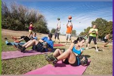 a group of people doing exercises on mats in the park with balls and basketballs