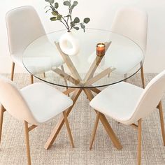 a glass table with white chairs around it