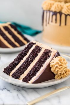 a slice of chocolate cake on a plate with the rest of the cake in the background