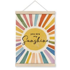 a wooden sign with the words you are my sunshine painted in multicolored stripes