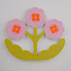 three pink flowers with green leaves on a white background and yellow border around the edges