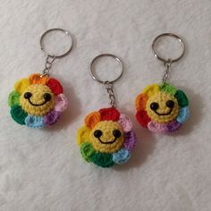 two crocheted keychains with smiley faces on them