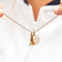 Keep a piece of Paris close to your heart with our Personalized Eiffel Tower Necklace. An iconic landmark in jewelry form, each necklace features a mini Eiffel Tower charm to pair with a shiny, engravable disc. Personalize with a special memory or a romantic dedication, with each disc being delicately hand-engraved and sent from the city of love itself.&nbsp;18K Champagne Gold Plated or 925 Sterling SilverCharms measure: 0.6 x 0.6 (Small Flat Disc), 0.7 x 0.2 (Eiffel Tower Charm Gold Plated), 0.5 x 0.2 (Eiffel Tower Charm Sterling Silver)Charms are removable from this chain and can be worn on all Merci Maman chain lengthsEngraved by hand in our Paris workshopSent with love in a complimentary gift boxPlease note that necklaces that have several charms may develop a certain patina, givin Mini Eiffel Tower, Crystal Dice, Eiffel Tower Necklace, Paris Jewelry, City Of Love, Usa Jewelry, Grandmother Gifts, Small Flat, Crystal Stars