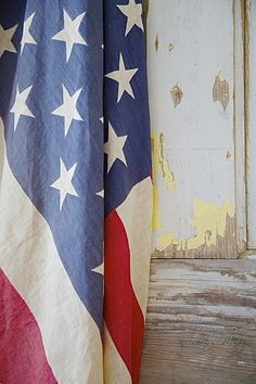 an american flag draped over a window sill