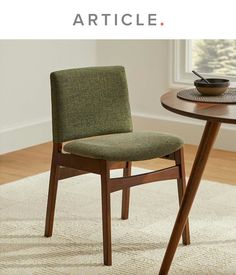 a green chair sitting next to a wooden table