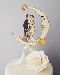 a wedding cake with a bride and groom on the moon