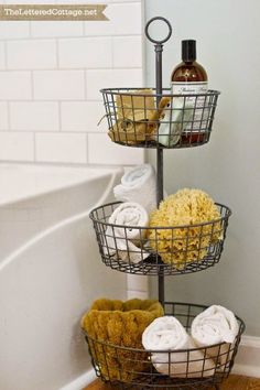 three tiered basket with towels and soaps in it