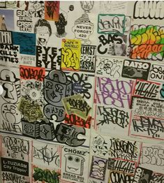 the wall is covered with graffiti and stickers