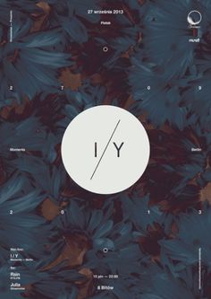 a white circle with the word y on it surrounded by blue leaves and brown flowers