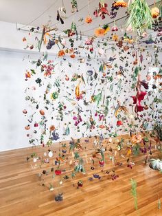 a room filled with lots of different types of objects hanging from the ceiling and on strings