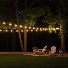 an outdoor patio with string lights and chairs