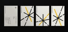 four white business cards with black and yellow lines