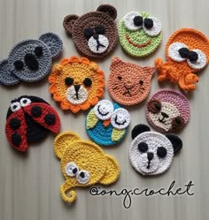 the crocheted animal faces are arranged in different colors and sizes, along with black eyes