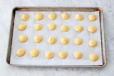 doughnut holes on a baking sheet ready to go into the oven