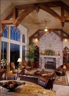 a living room filled with lots of furniture and a fire place in the middle of it