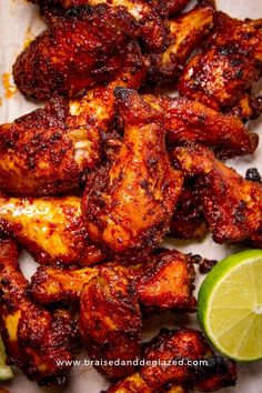 chicken wings with lime wedges on the side