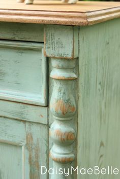 an old dresser with peeling paint on it's drawers and wood top that has been stripped off