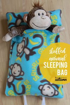 a stuffed animal sleeping bag with a monkey on it